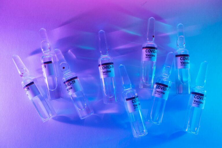 ampoules with antivirus vaccines arranged on desk in laboratory