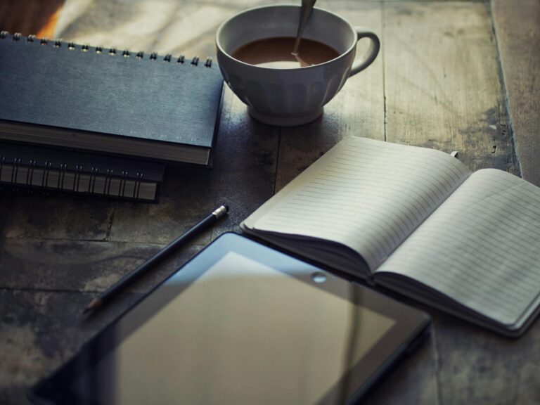 cup filled with coffee near book